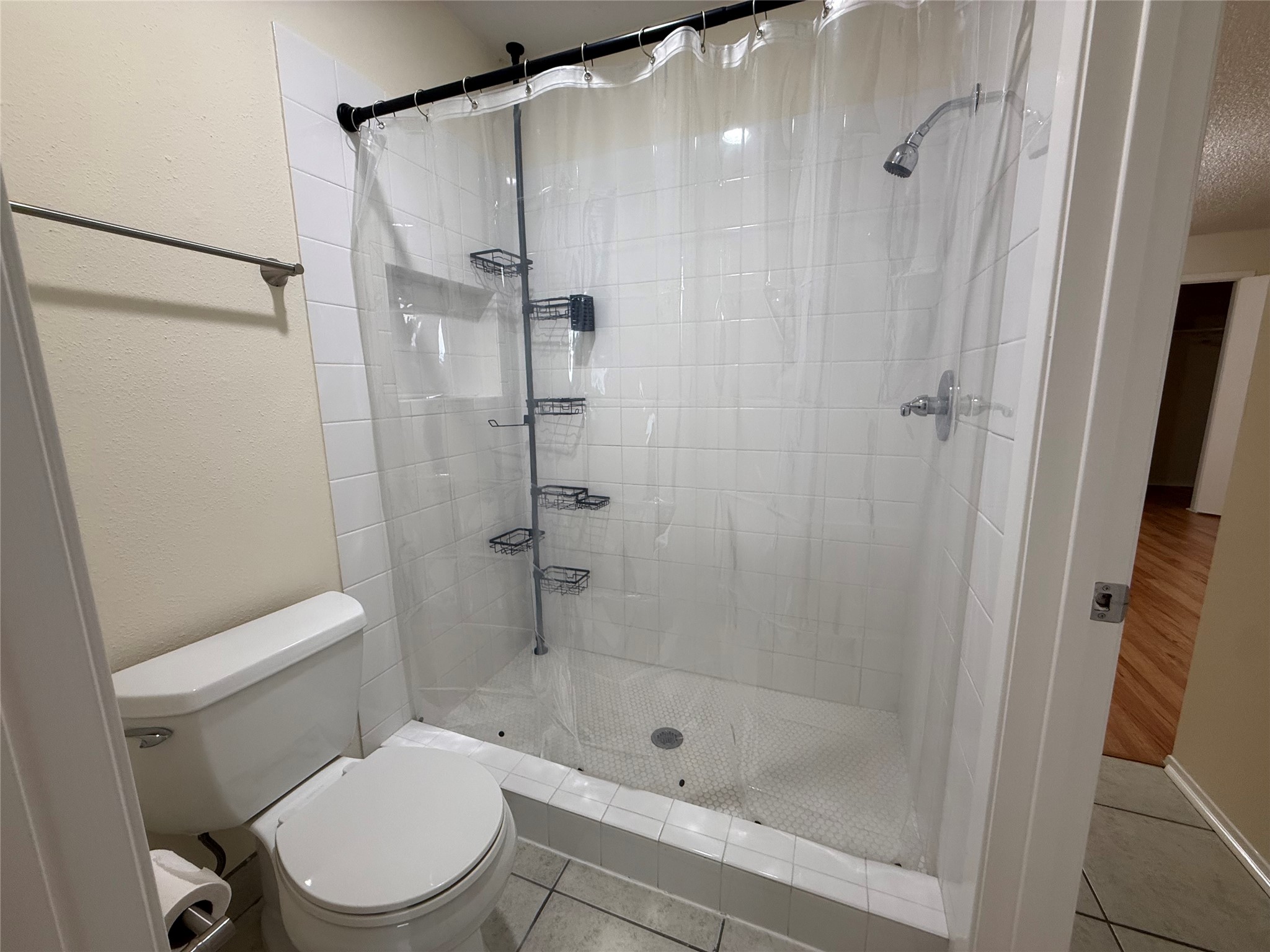 3837 Tanglewilde Street, Unit 3837 Houston, TX 77063 - Photo 7 of 12 a white toilet sitting next to a bathroom