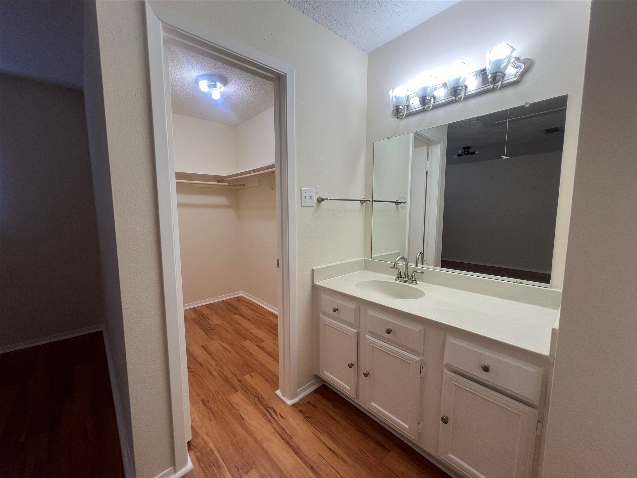 3837 Tanglewilde Street, Unit 3837 Houston, TX 77063 - Photo 9 of 12 a bathroom with a double vanity sink and mirror