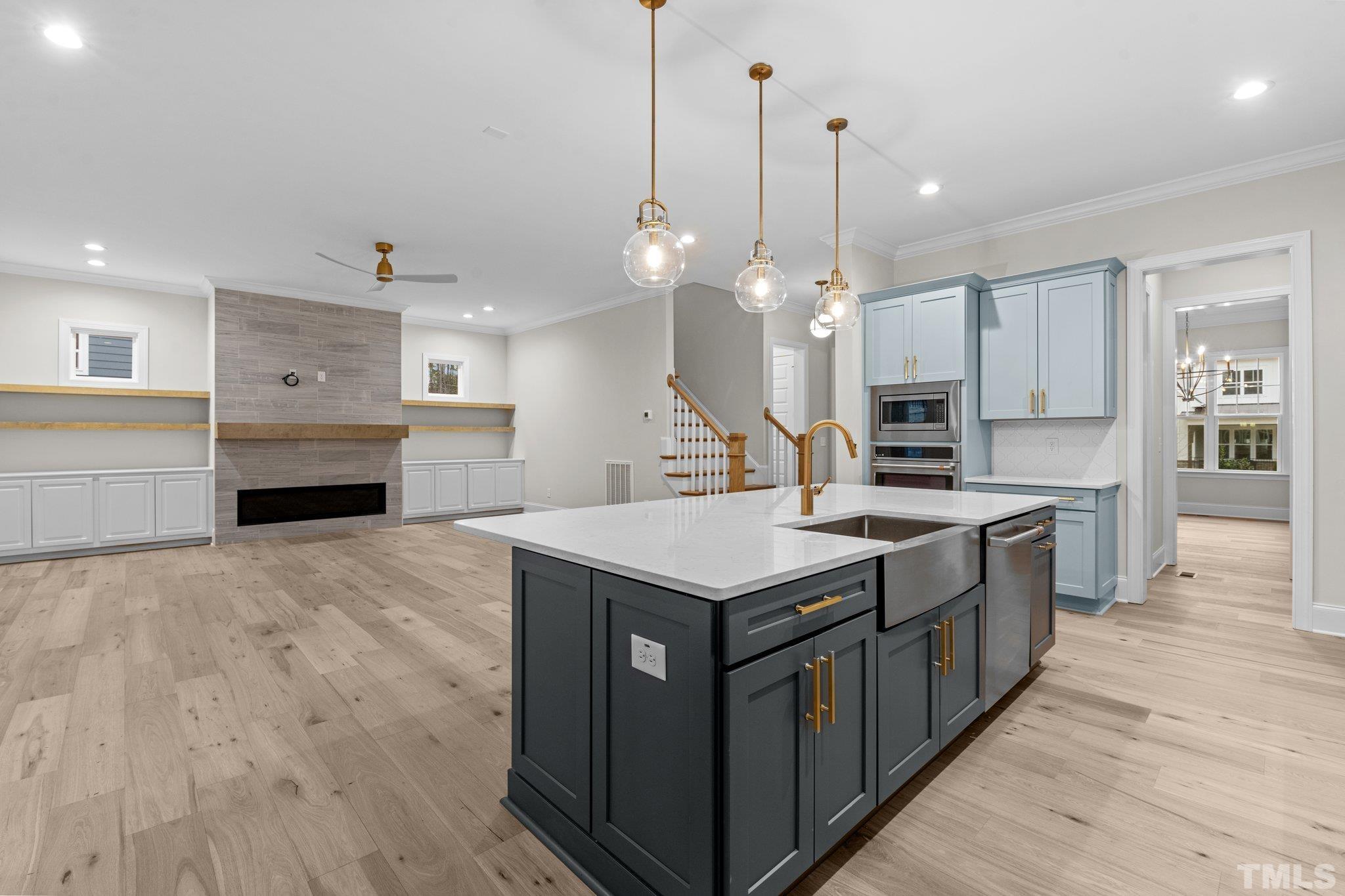 9321 Field Maple Court Raleigh, NC 27613 - Photo 13 of 44 a kitchen with granite countertop a sink a counter top space stainless steel appliances and a chandelier