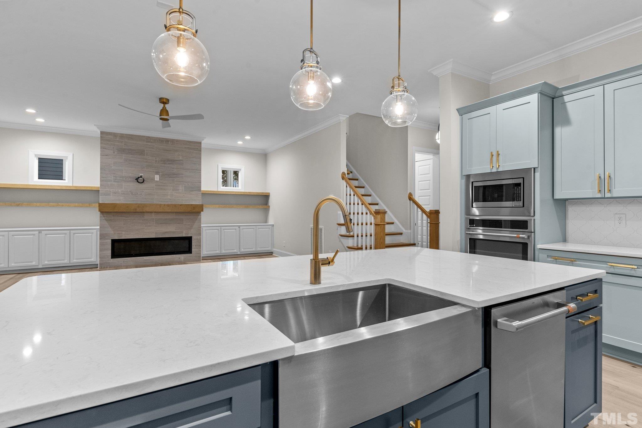 9321 Field Maple Court Raleigh, NC 27613 - Photo 14 of 44 a kitchen with a sink a refrigerator and a stove