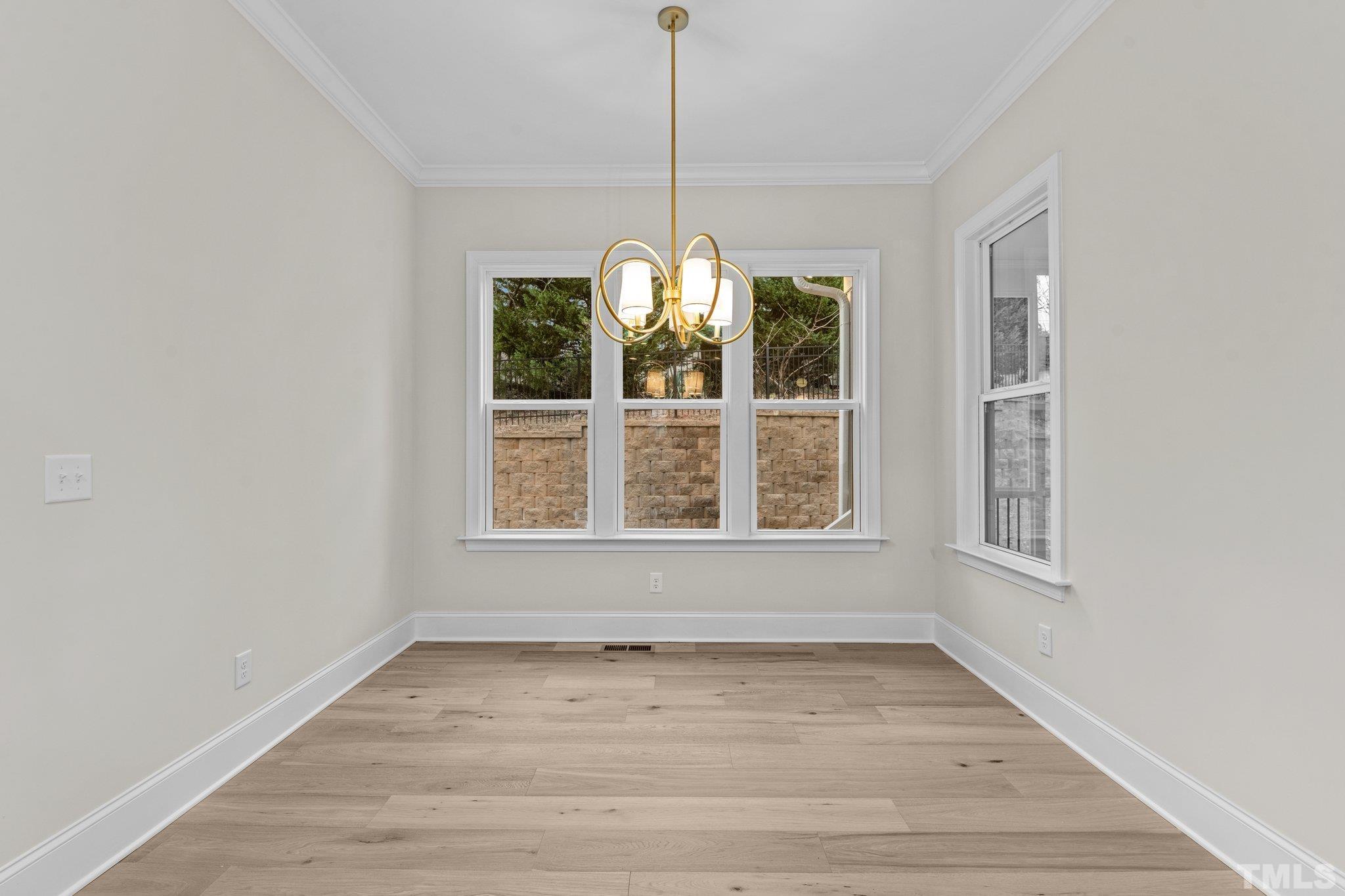 9321 Field Maple Court Raleigh, NC 27613 - Photo 15 of 44 a view of an empty room with wooden floor and a window