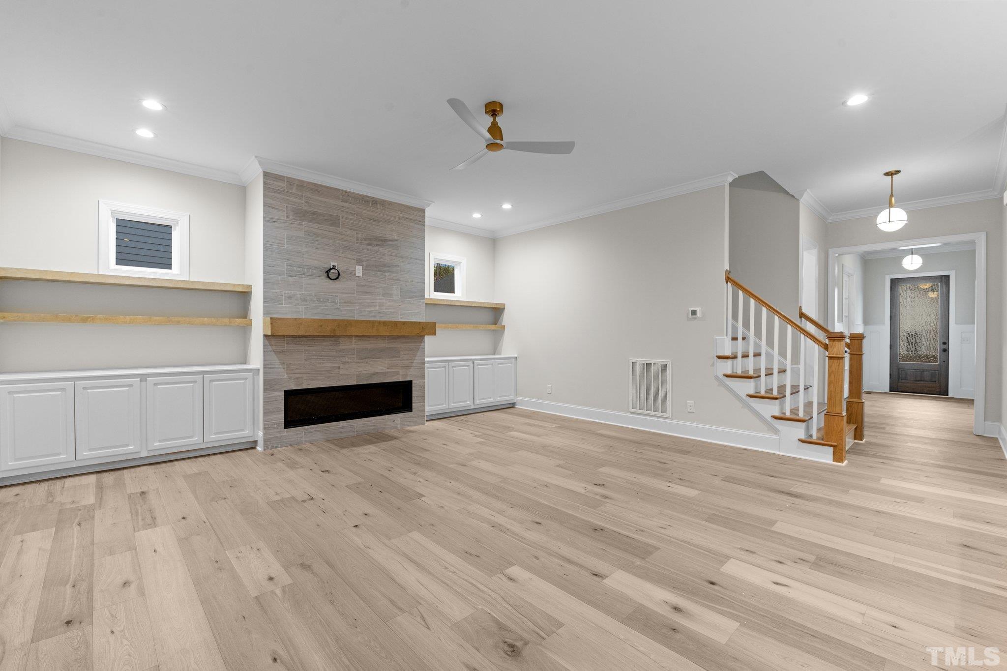 9321 Field Maple Court Raleigh, NC 27613 - Photo 17 of 44 a view of an empty room with wooden floor fireplace and a window