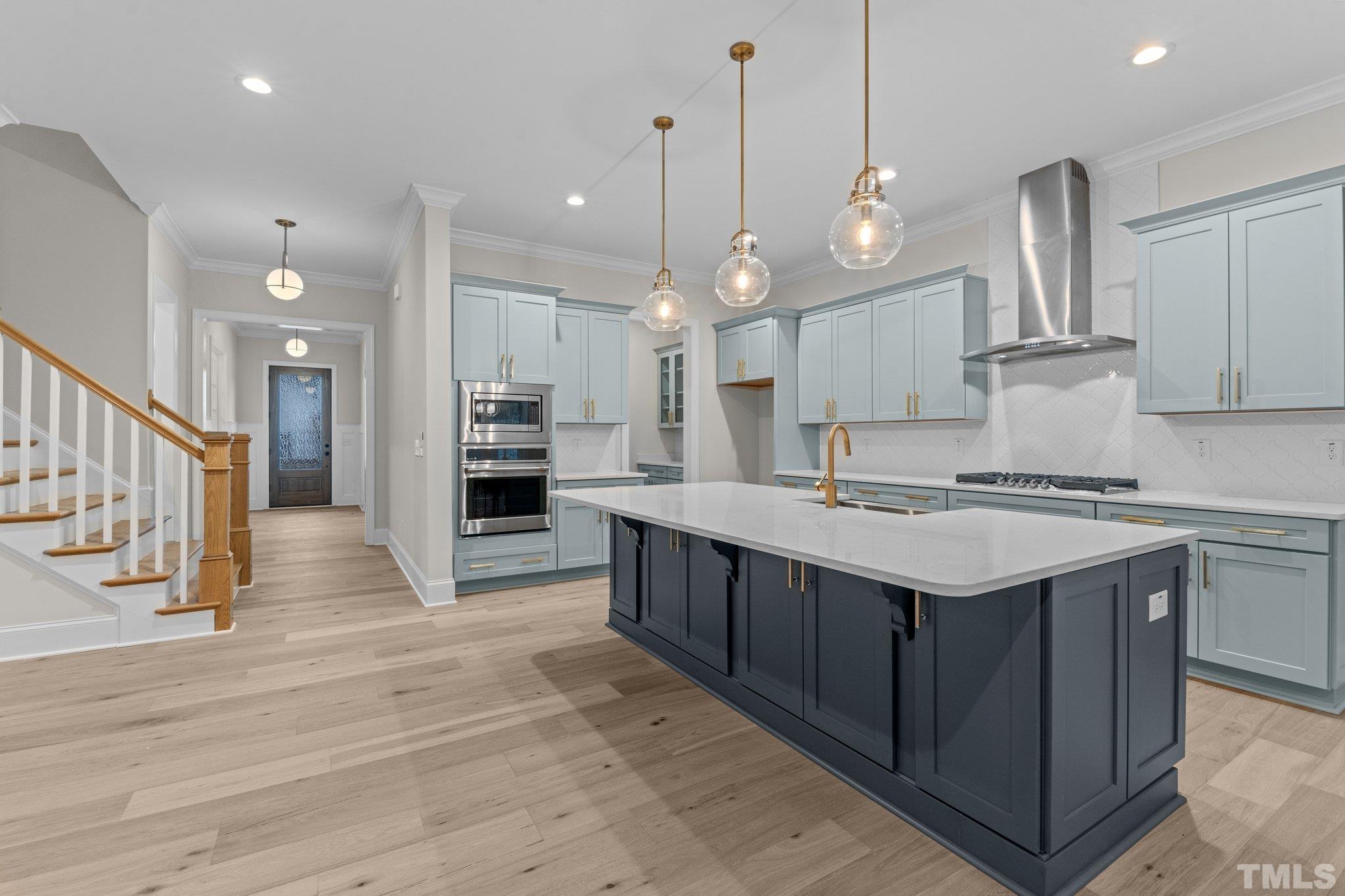 9321 Field Maple Court Raleigh, NC 27613 - Photo 18 of 44 a large kitchen with stainless steel appliances kitchen island a large island in the center