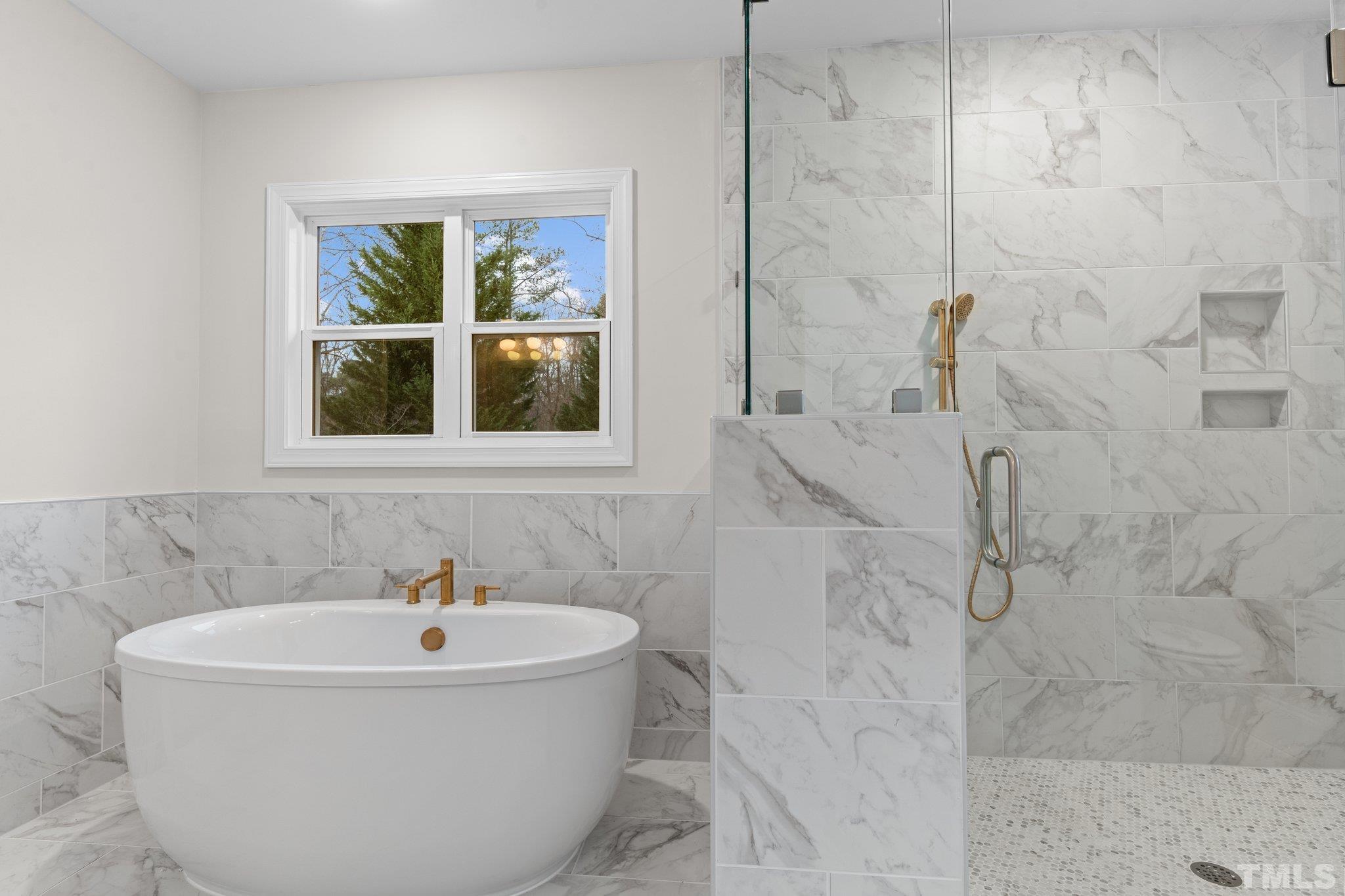 9321 Field Maple Court Raleigh, NC 27613 - Photo 29 of 44 a white bath tub sitting next to a window