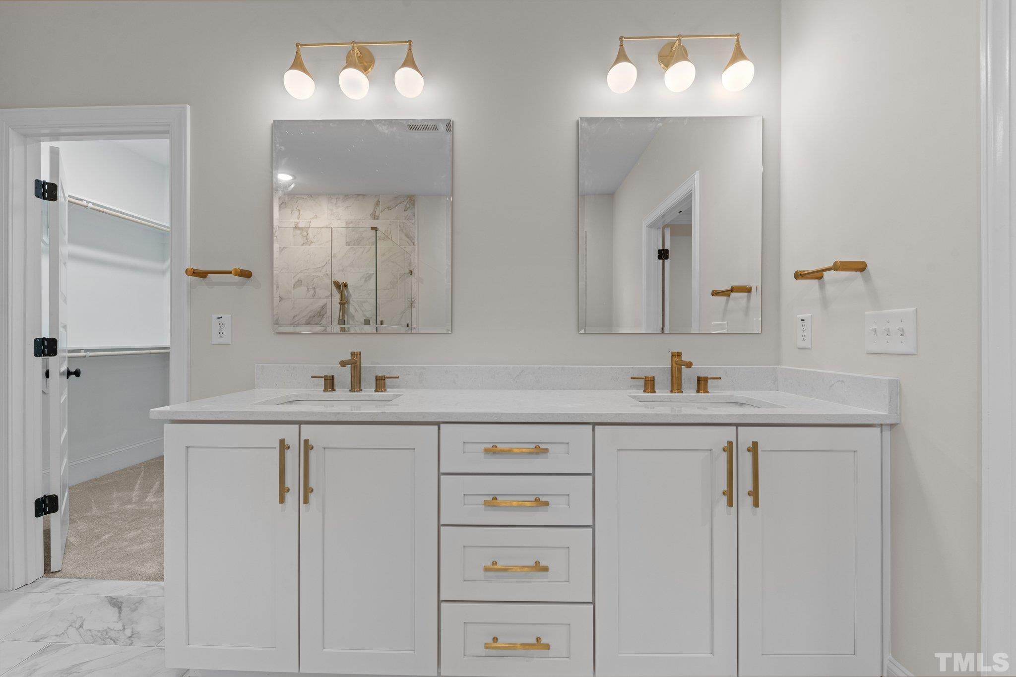 9321 Field Maple Court Raleigh, NC 27613 - Photo 30 of 44 a bathroom with double vanity sink and a mirror