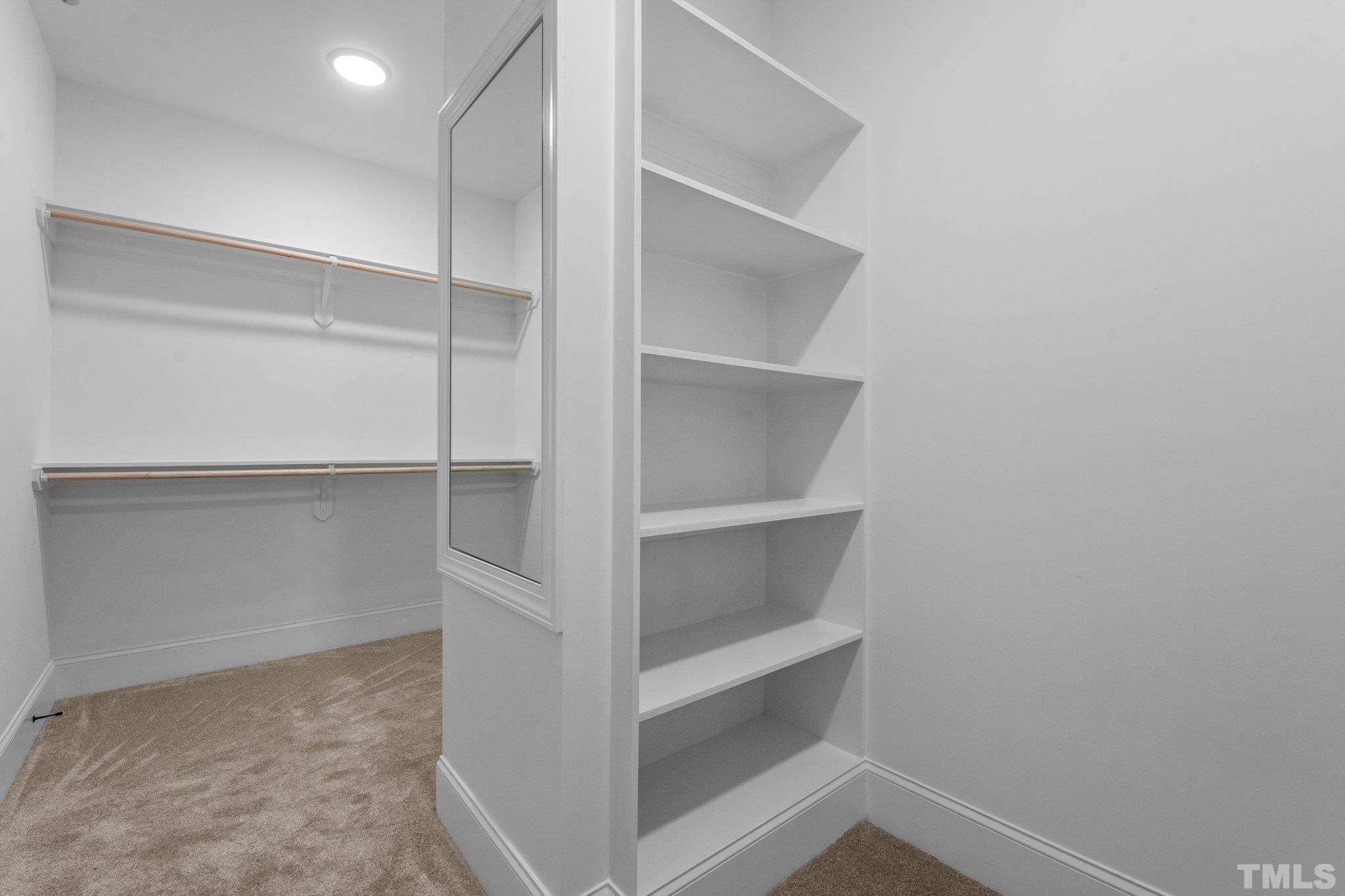 9321 Field Maple Court Raleigh, NC 27613 - Photo 31 of 44 a view of walk in closet with empty racks