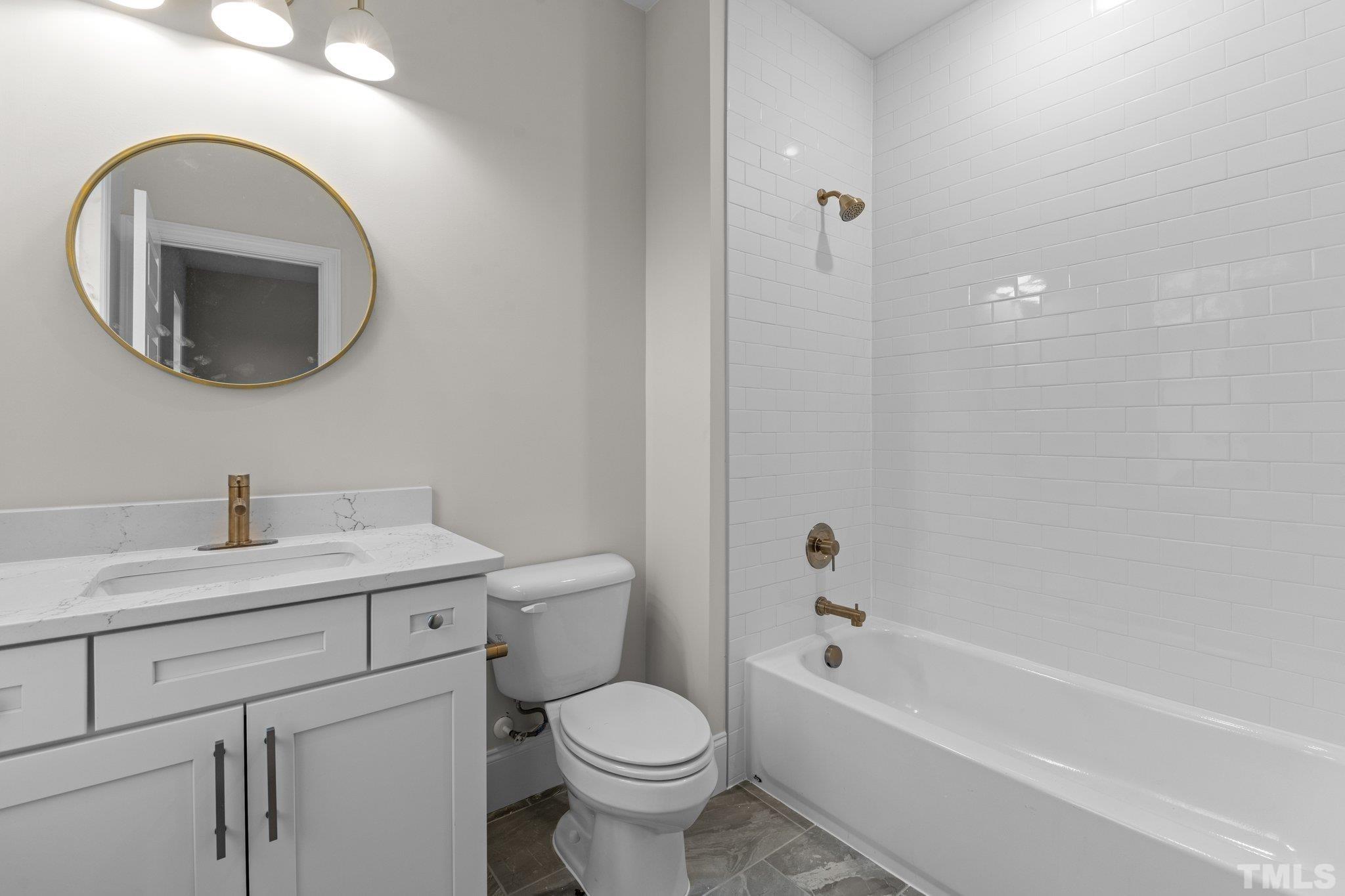 9321 Field Maple Court Raleigh, NC 27613 - Photo 35 of 44 a bathroom with a toilet sink and mirror