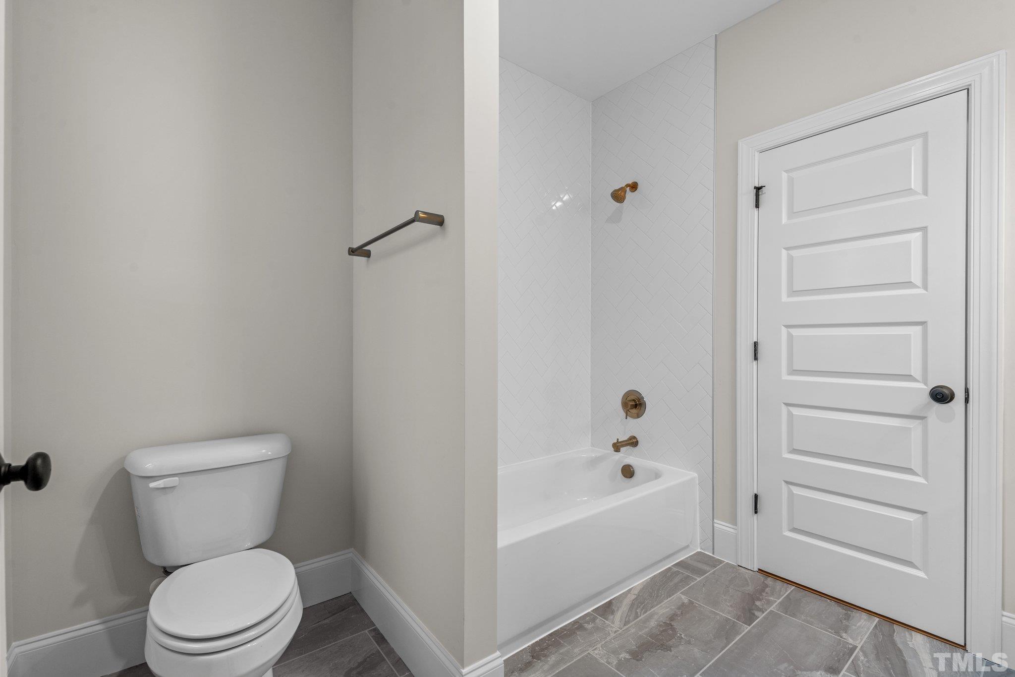 9321 Field Maple Court Raleigh, NC 27613 - Photo 37 of 44 a white toilet sitting next to a bathroom sink