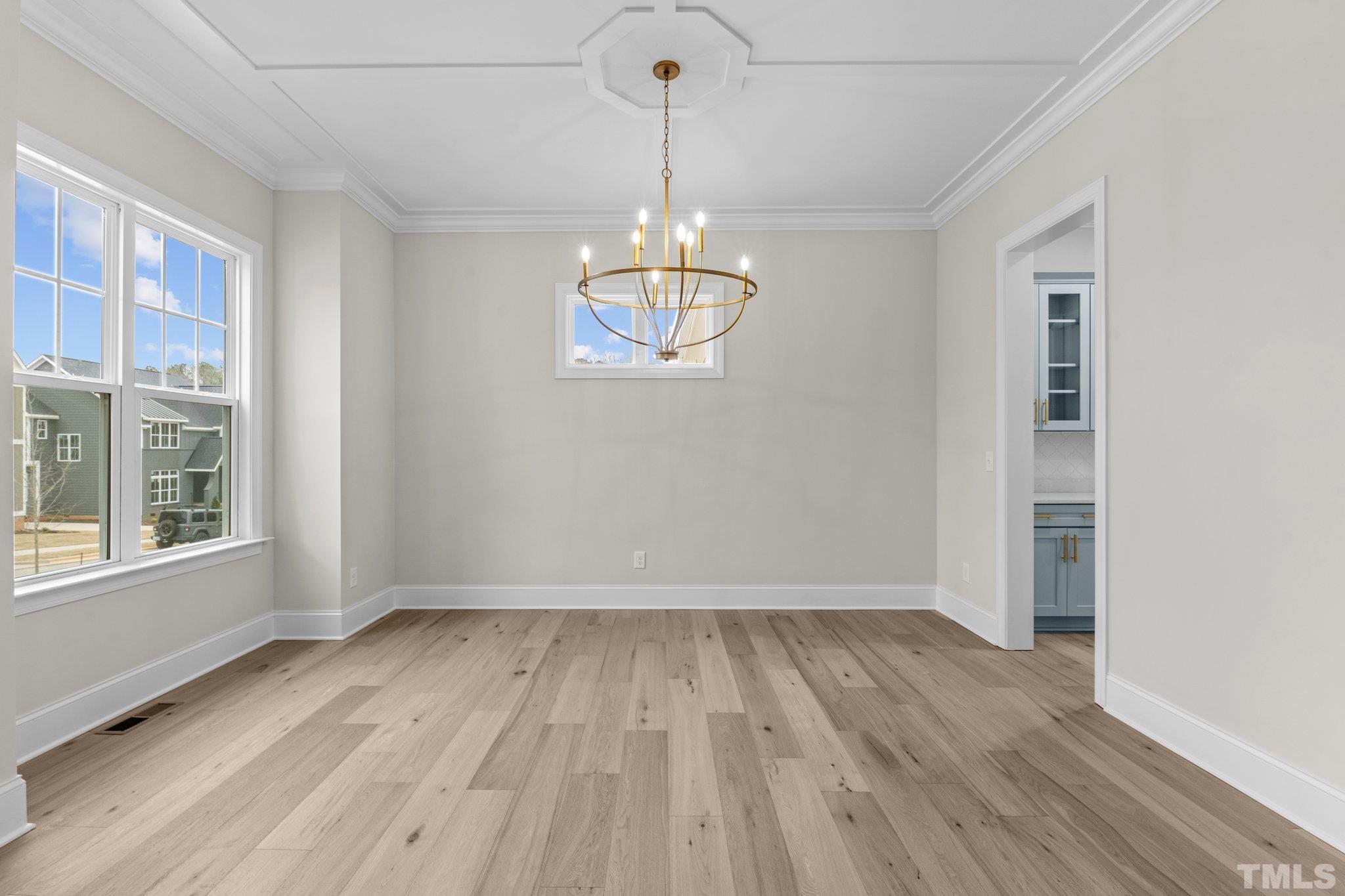 9321 Field Maple Court Raleigh, NC 27613 - Photo 5 of 44 a view of empty room with wooden floor and fan