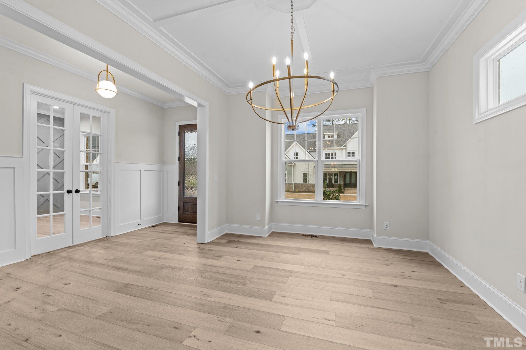 9321 Field Maple Court Raleigh, NC 27613 - Photo 6 of 44 a view of empty room with wooden floor and chandelier