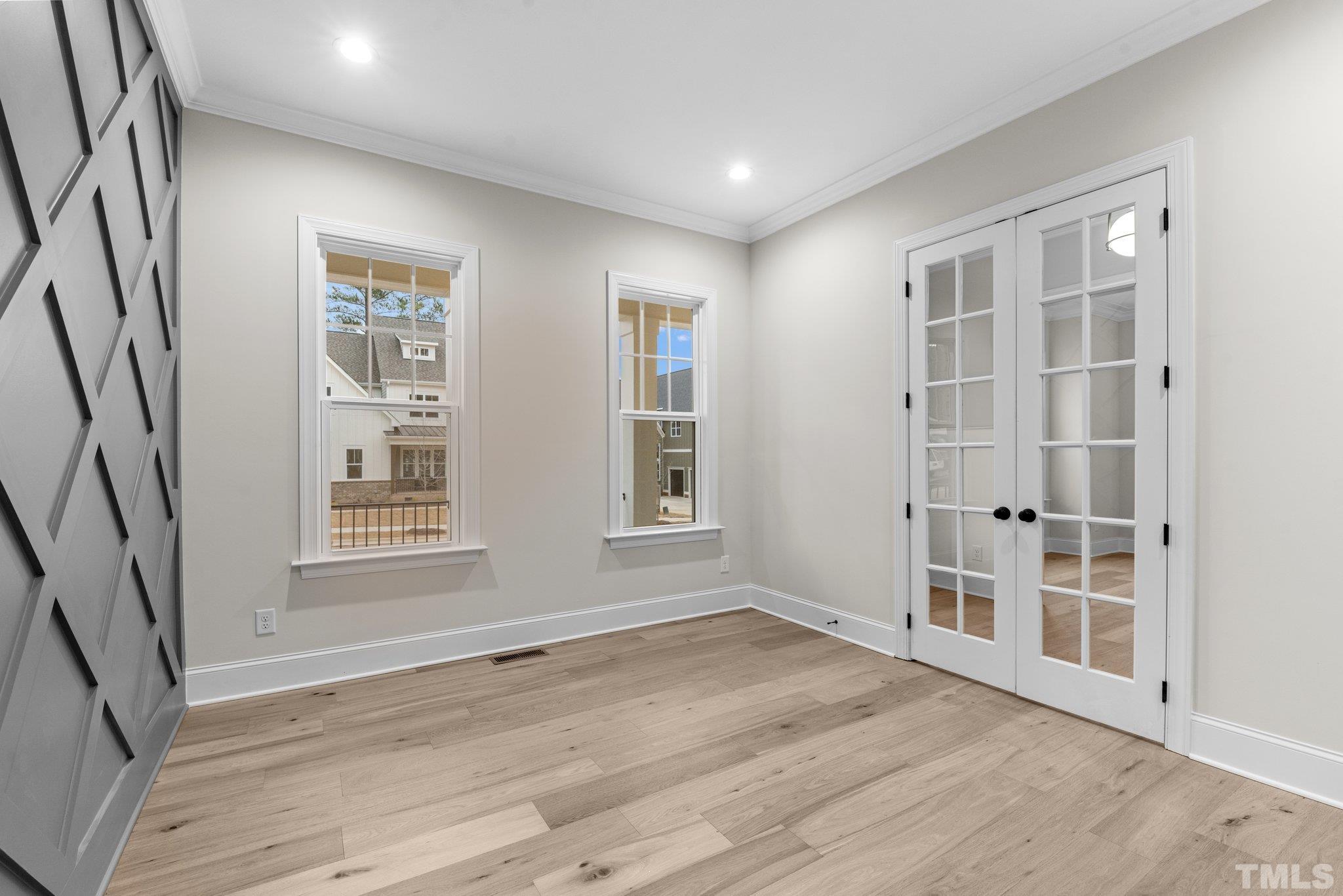 9321 Field Maple Court Raleigh, NC 27613 - Photo 7 of 44 an empty room with wooden floor and windows