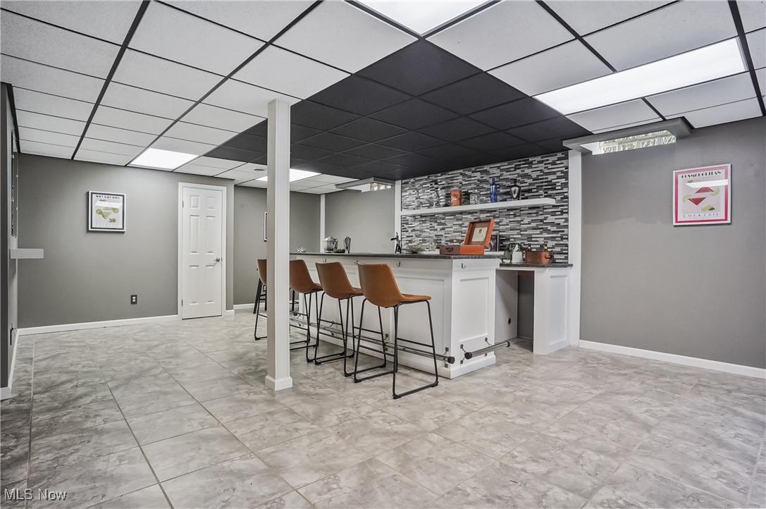 370 Wilcox Road Youngstown, OH 44515 - Photo 36 of 49 Indoor wet bar with a paneled ceiling and baseboards
