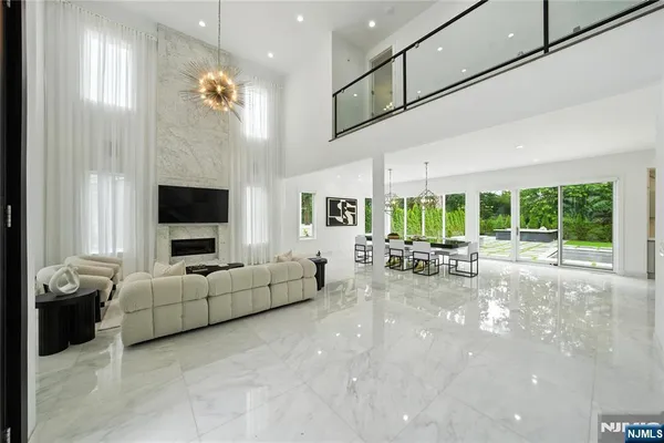 a large kitchen with stainless steel appliances a large counter top a stove and a refrigerator