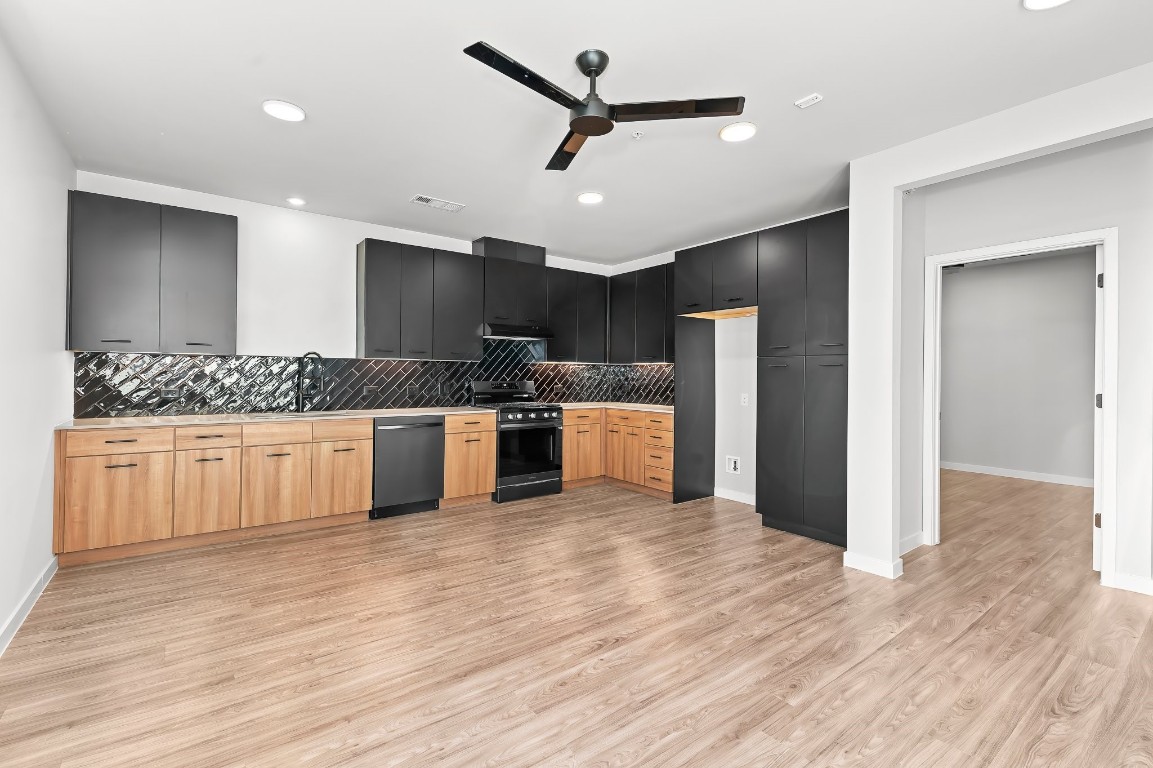 4510 Terry-O Lane, Unit 143 Austin, TX 78745 - Photo 11 of 20 a kitchen with stainless steel appliances kitchen island granite countertop a refrigerator and a stove top oven