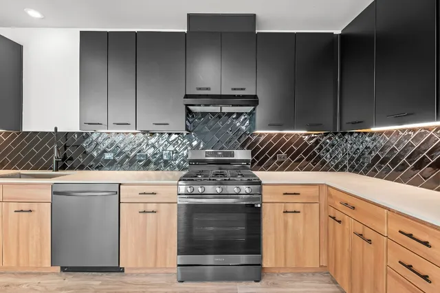 a kitchen with granite countertop a stove and cabinets