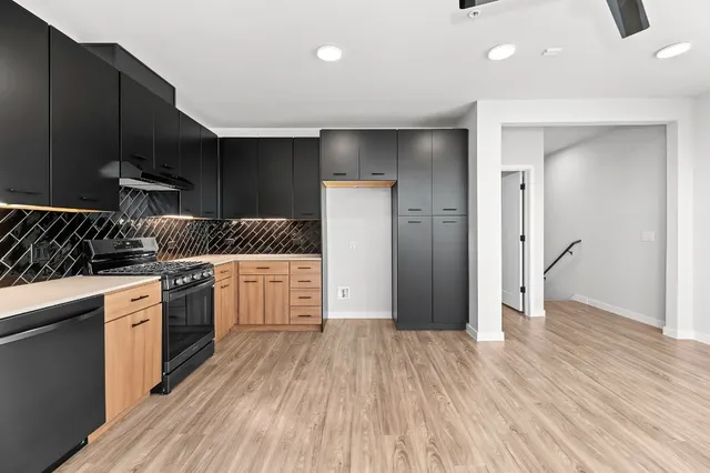 a kitchen with stainless steel appliances a refrigerator sink and cabinets