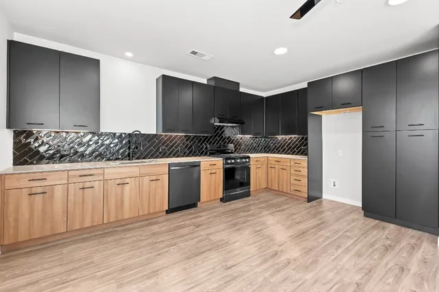 a kitchen with a sink stove and refrigerator