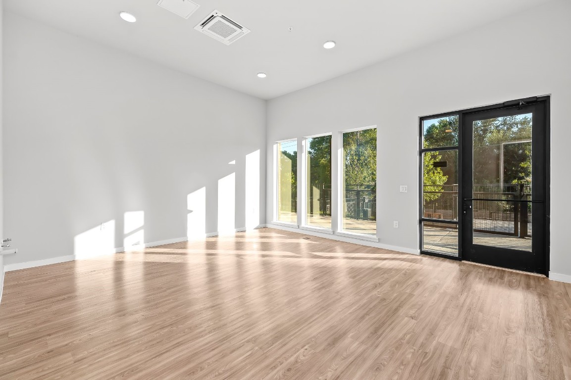 4510 Terry-O Lane, Unit 143 Austin, TX 78745 - Photo 5 of 20 a view of an empty room with wooden floor and a window