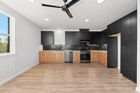 a large kitchen with a stove and a refrigerator