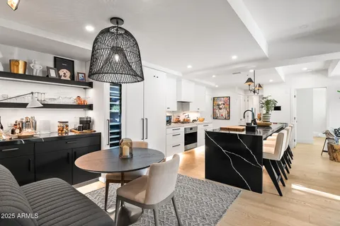a view of kitchen with stainless steel appliances kitchen island wooden cabinets and fireplace