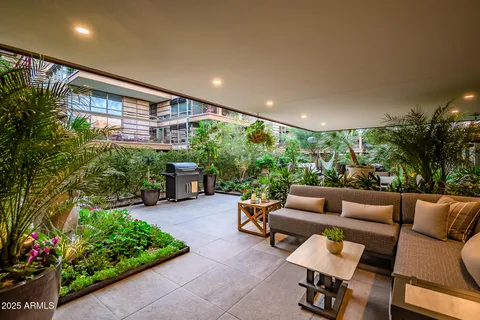 a view of a patio with a table and chairs and potted plants