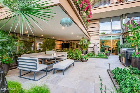a view of a patio with table and chairs and potted plants