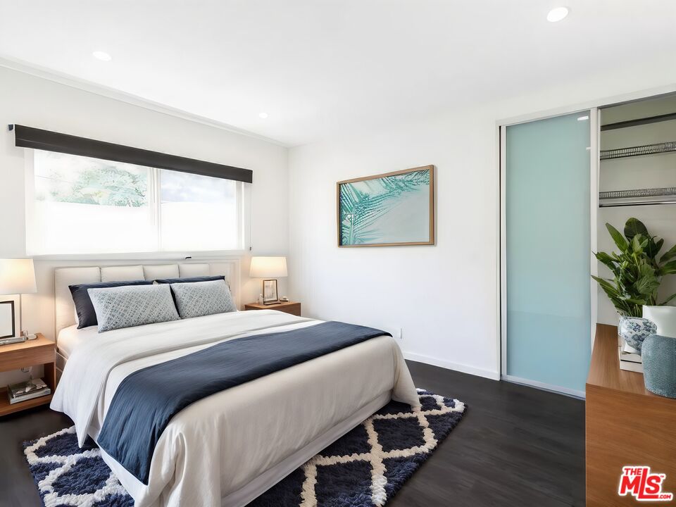 1434 10th Street, Unit 8 Santa Monica, CA 90401 - Photo 2 of 10 a bedroom with a bed and a potted plant