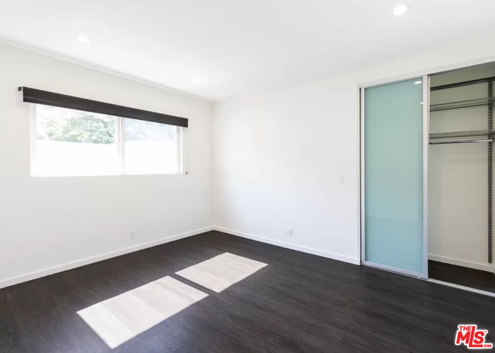 1434 10th Street, Unit 8 Santa Monica, CA 90401 - Photo 6 of 10 an empty room with wooden floor and a window