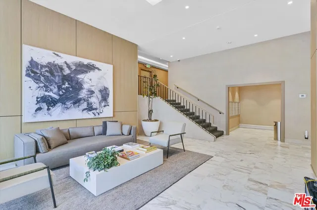 a view of a walk in closet and living room