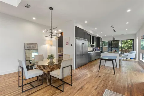 a dining room with furniture and wooden floor