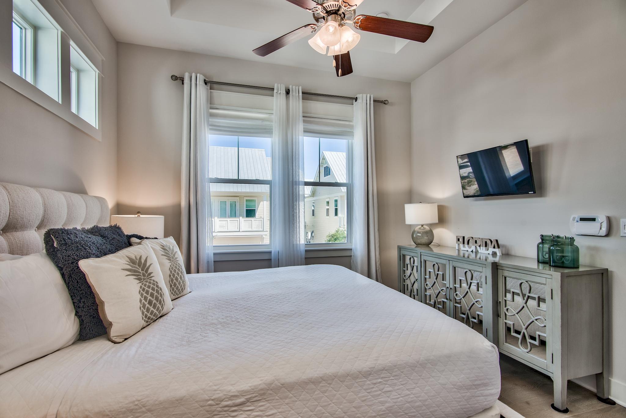 33 Milestone Dr Inlet Beach, Unit C Inlet Beach, FL 32461 - Photo 11 of 24 a bedroom with a bed and a flat tv screen on dresser