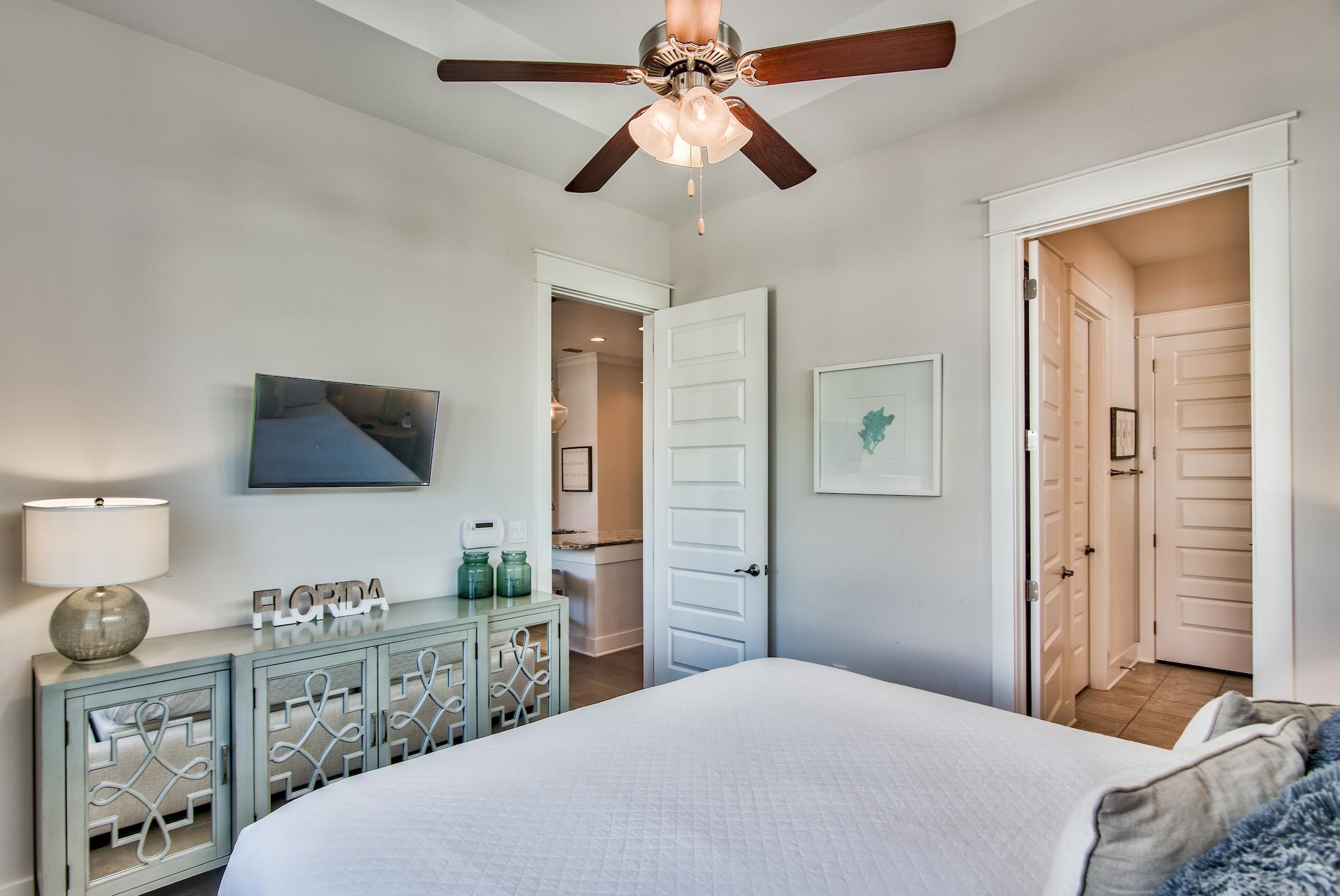 33 Milestone Dr Inlet Beach, Unit C Inlet Beach, FL 32461 - Photo 12 of 24 a bedroom with a bed and a chandelier