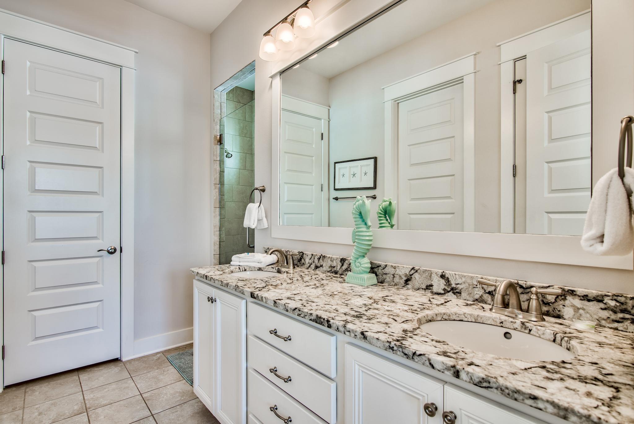 33 Milestone Dr Inlet Beach, Unit C Inlet Beach, FL 32461 - Photo 13 of 24 a bathroom with a granite countertop sink and a mirror