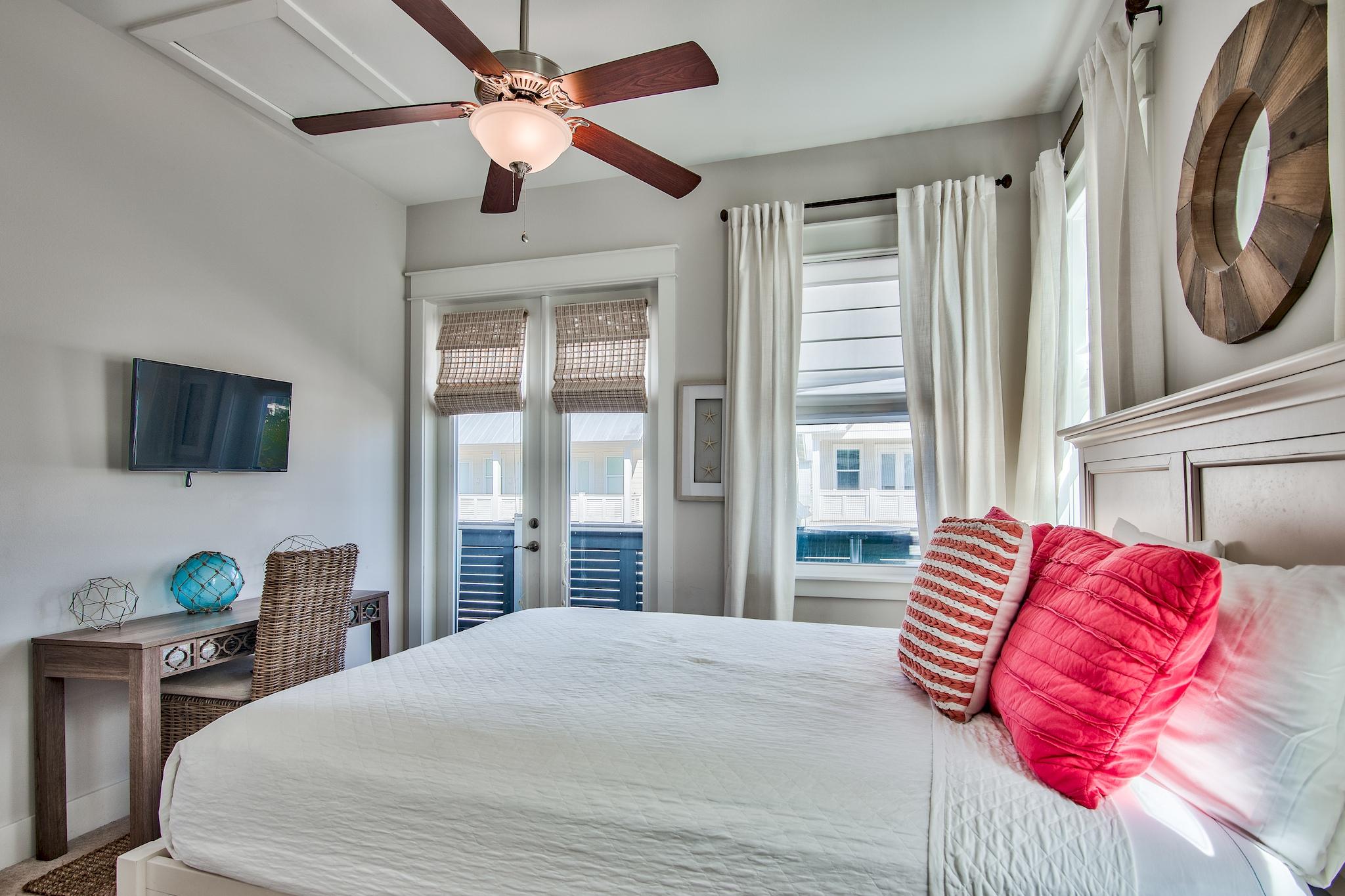 33 Milestone Dr Inlet Beach, Unit C Inlet Beach, FL 32461 - Photo 16 of 24 a bedroom with a large bed and a flat screen tv