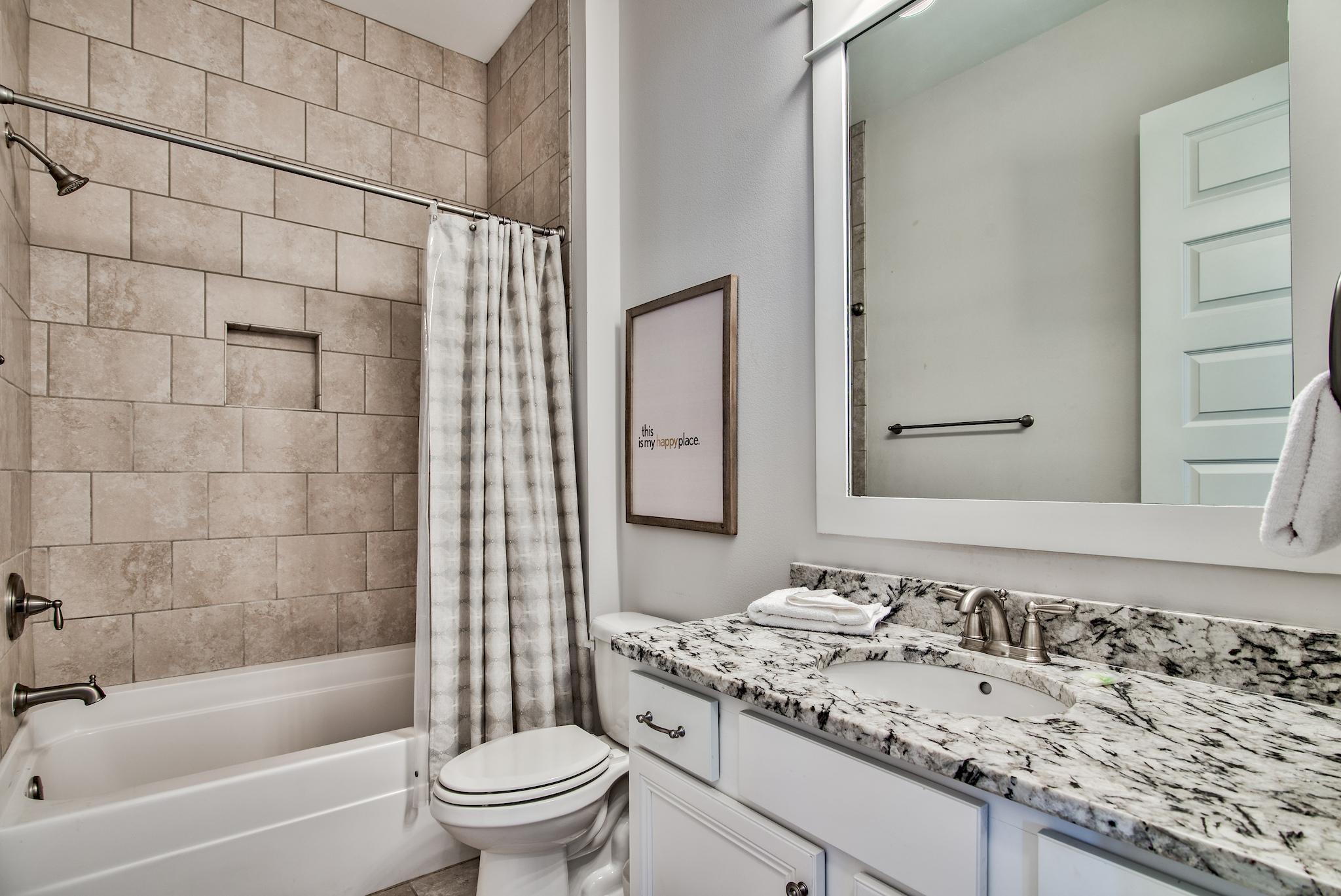 33 Milestone Dr Inlet Beach, Unit C Inlet Beach, FL 32461 - Photo 18 of 24 a bathroom with a granite countertop sink a toilet and shower