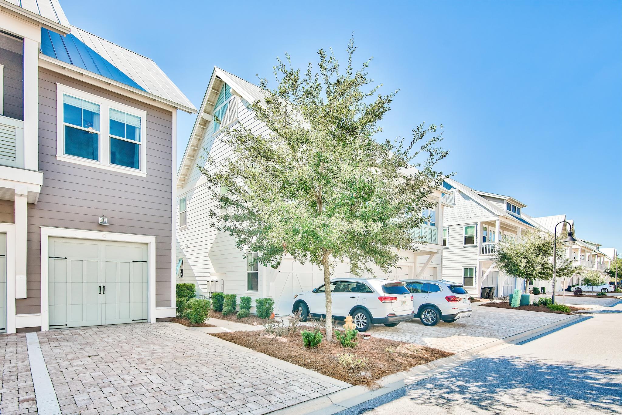 33 Milestone Dr Inlet Beach, Unit C Inlet Beach, FL 32461 - Photo 23 of 24 a street view with tall buildings and a yard