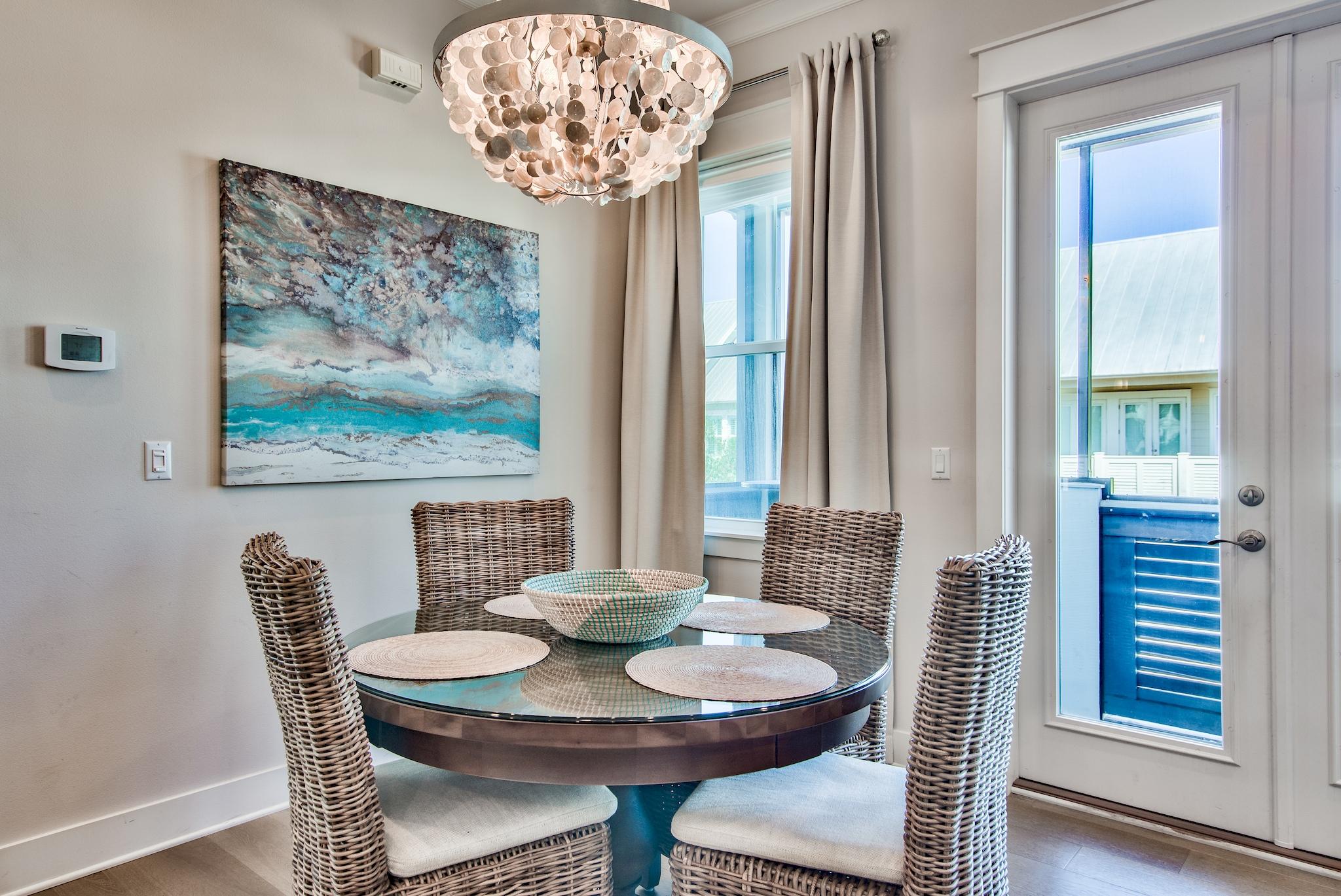 33 Milestone Dr Inlet Beach, Unit C Inlet Beach, FL 32461 - Photo 5 of 24 a view of a dining room with furniture wooden floor and a chandelier