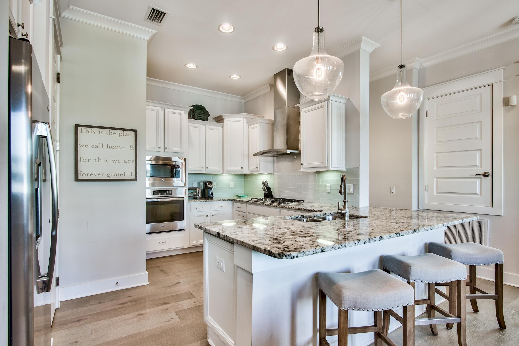 33 Milestone Dr Inlet Beach, Unit C Inlet Beach, FL 32461 - Photo 7 of 24 a kitchen with stainless steel appliances granite countertop a sink refrigerator and cabinets