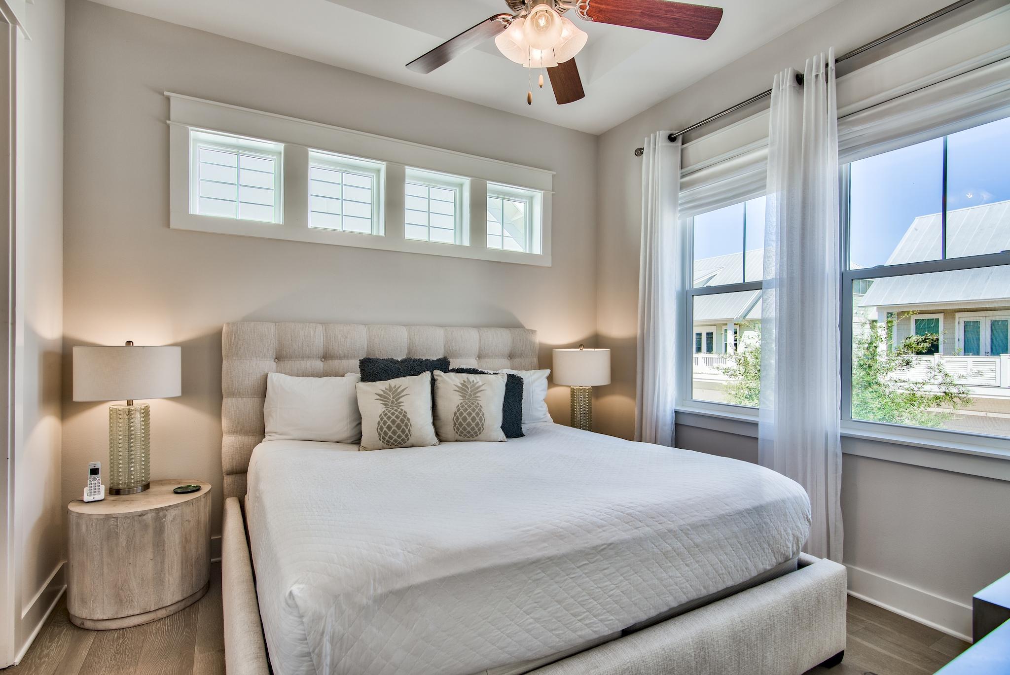 33 Milestone Dr Inlet Beach, Unit C Inlet Beach, FL 32461 - Photo 10 of 24 a bedroom with a large bed and chandelier