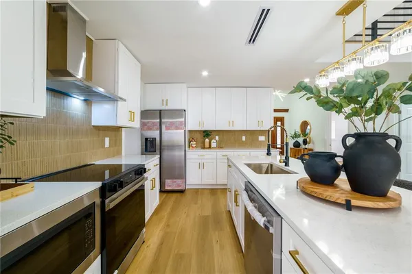 a kitchen with a refrigerator and cabinets