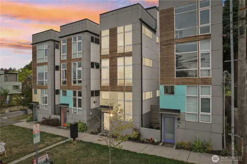 a front view of a building with a garden