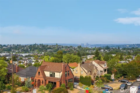 an aerial view of residential houses with city view
