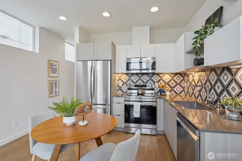 a kitchen with stainless steel appliances a stove a sink and a refrigerator