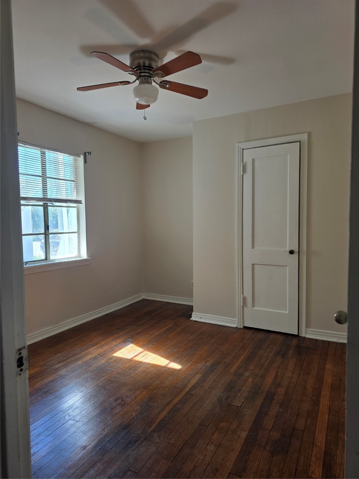 3817 South Shepherd Drive, Unit 2 Houston, TX 77098 - Photo 4 of 11 an empty room with wooden floor chandelier fan and windows