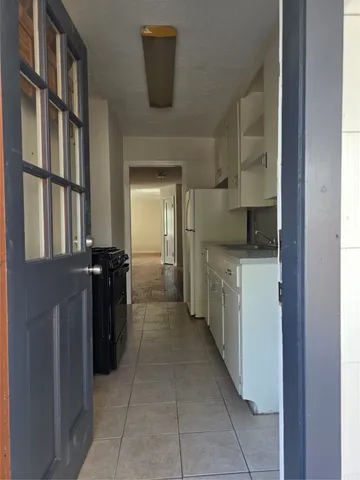 a kitchen with a refrigerator and a sink