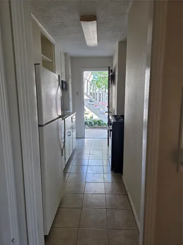 a kitchen with a refrigerator and microwave