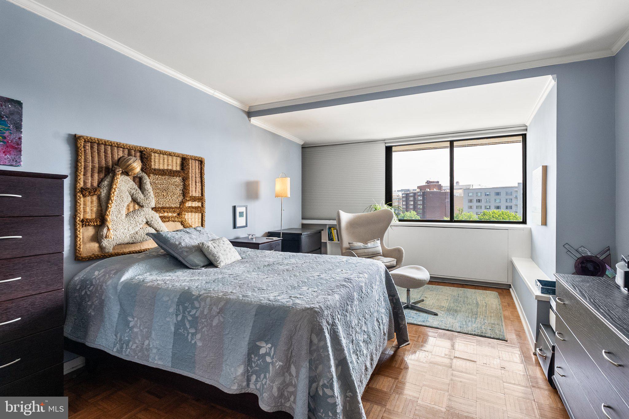 2500 Virginia Avenue Northwest, Unit 906S Washington, DC 20037 - Photo 21 of 39 a bedroom with a bed and a large window