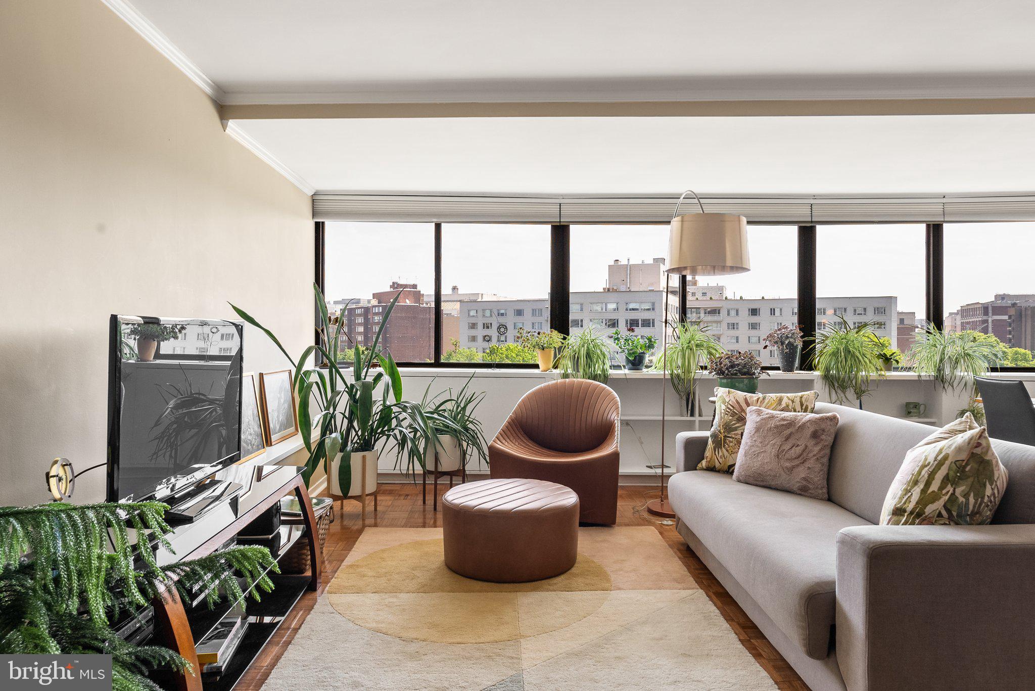 2500 Virginia Avenue Northwest, Unit 906S Washington, DC 20037 - Photo 6 of 39 a living room with furniture tv and a floor to ceiling window