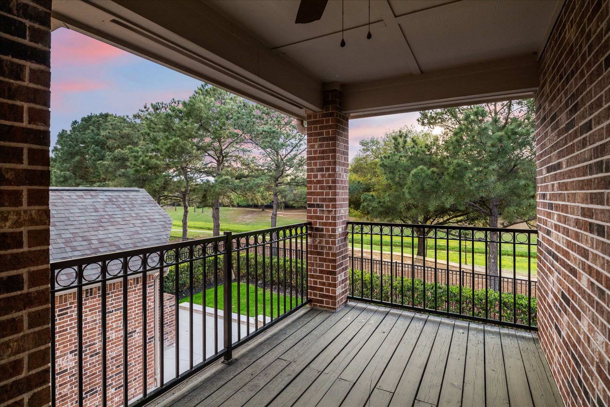 6211 Alameda Point Lane Houston, TX 77041 - Photo 31 of 50 Covered balcony off the upstairs game room featuring iron railing and sweeping views of the lush backyard, greenbelt, and sparkling saltwater pool.