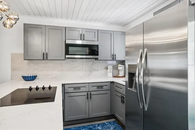 a kitchen with a refrigerator sink and microwave